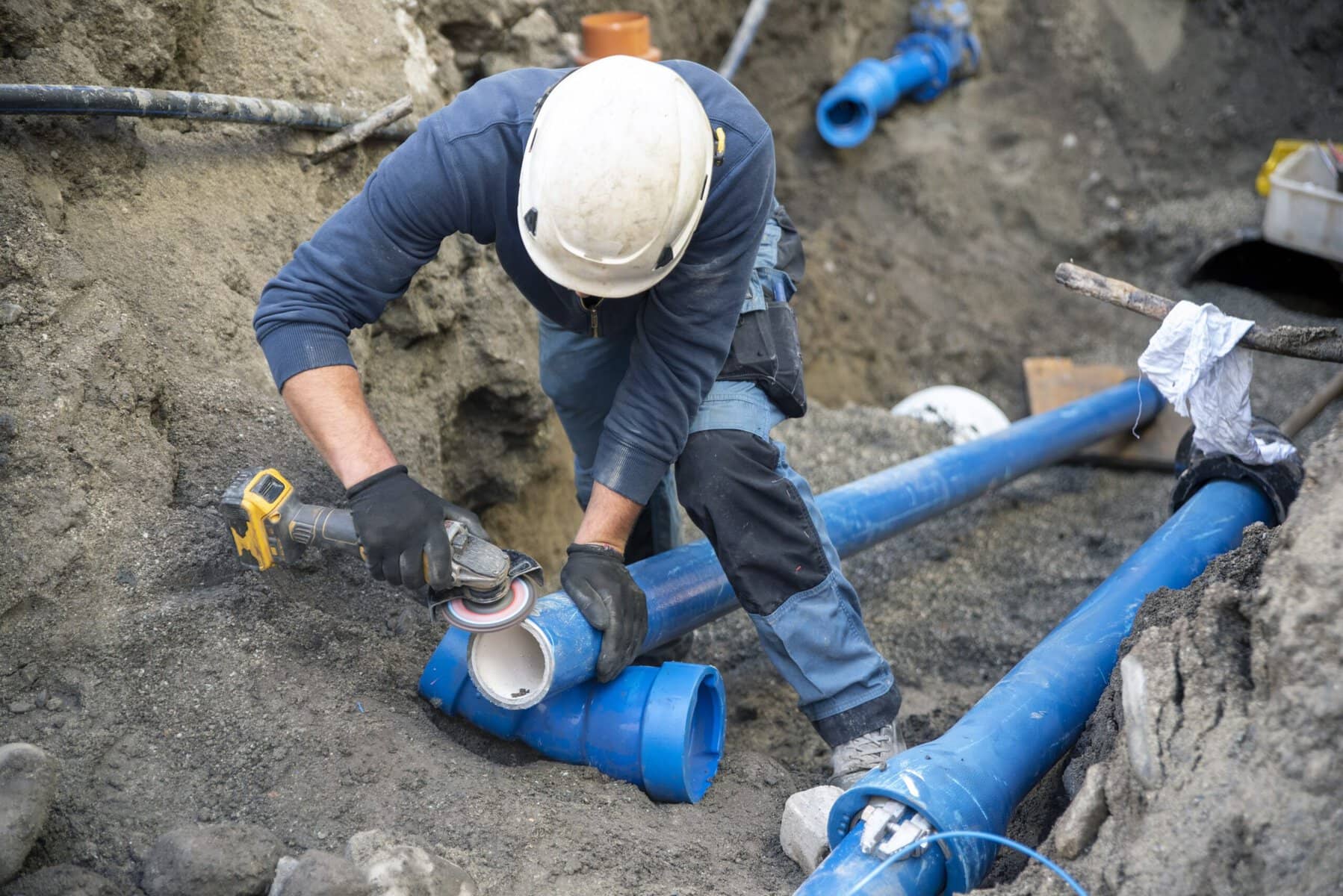 Technician repairing an excavated sewer line