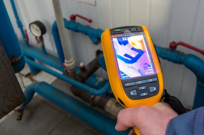 Thermal imaging camera detecting a hidden leak in pipes
